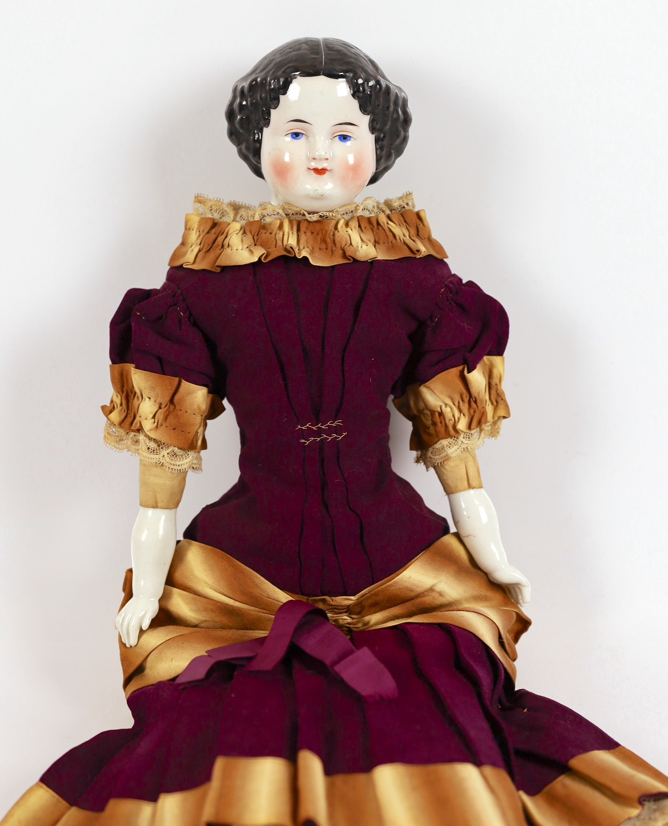 A glazed shoulder china head doll, c.1870, 53cm, some rubbing of hair, cloth body, original dress in very good condition